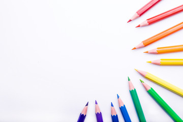 Fototapeta premium Different color pencils on white background. Composition with colored pencils, closeup view, space for text