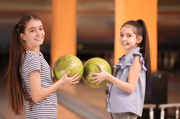 Fototapeta premium Happy girls with balls in bowling club