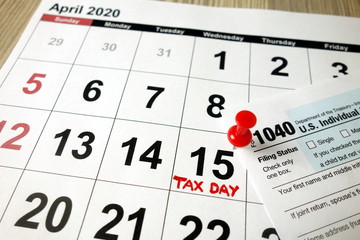 Monthly calendar showing date April 15th 2020 marked as tax day with 1040 form