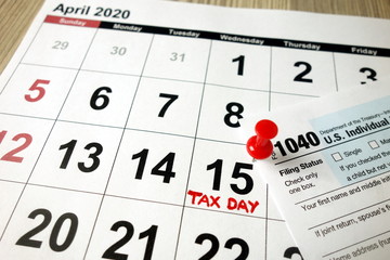 Monthly calendar showing date April 15th 2020 marked as tax day with 1040 form