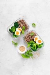 Lunch boxes with broccoli, quinoa and egg, healthy  food, balanced eating concept, top view