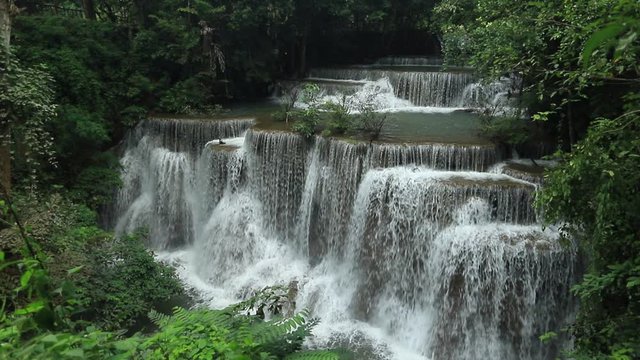 Scenic nature of beautiful Huai Mae Khamin waterfall and emerald pool of fresh water lake in wild jungle forest environment in Thailand. Travel and adventure landscape of amazing asia.