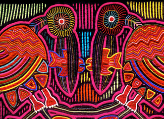 Cuna Mola panel with pelican and fish motif, using the reverse appliqué technique to expose colorful underling layers, San Blas Islands, Panama © John Nakata
