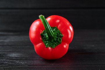 red bell pepper on a black wooden background, still life, food photography