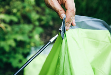 Obraz premium Man installing tent. Tourist outdoors. Camping in the forest.