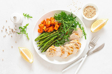 Grilled chicken breast, fillet with butternut squash or pumpkin, green beans and fresh arugula salad, healthy food, top view