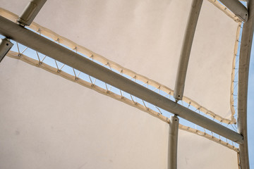 Awnings in sails shape over cloudy sky background