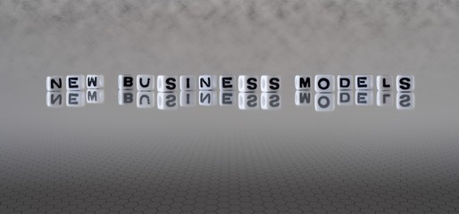 new business models concept represented by wooden letter tiles