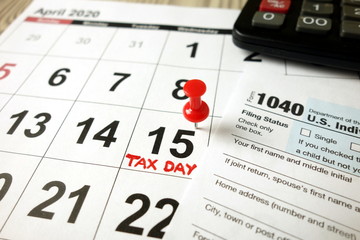 Calendar showing date April 15 2020, 1040 form and calculator