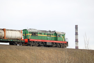 Naklejka premium diesel locomotive in an industrial zone