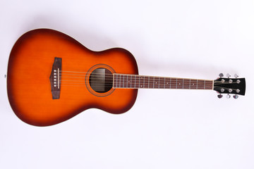 Folk style parlor acoustic guitar isolated on white background with a lot of copy space for text....