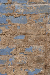 Old vintage shabby brick wall with peeling plaster. Grungy loft texture, background.