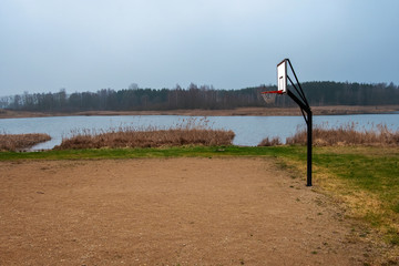 Fototapeta na wymiar outdoor basketball court by the pond