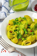 Pipe Rigate pasta with green pea sauce close up.