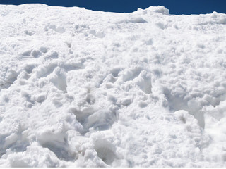 White snow background - real snow and a small pieace of the blue sky at the top