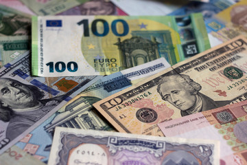 A lot of banknotes from different countries, money background. Dollars, euros, hryvnias, Russian rubles, Belarusian rubles and others.