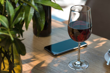 Glass Of Red Sweet Wine Illuminated By Sun Light In Modern Cafe Or Restaurant. 3d Rendering.