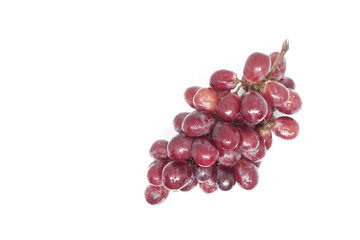 A bunch of red grapes and a white background