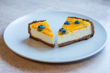 Grey plate with two pie of homemade cake with berry decorate on top