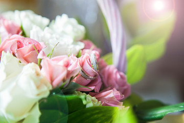 wedding precious ring of the bride and groom in a chic bouquet of flowers