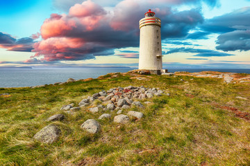 Stunning view of Skarsviti lighthouse in Vatnsnes peninsula on a clear day in North Iceland.
