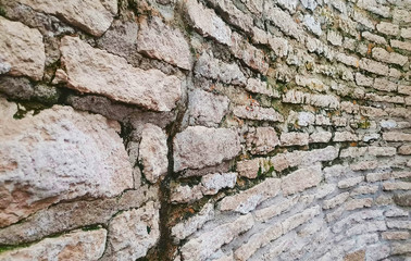 Ancent bricks wall with the moss on it.