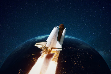 Rocket flies in open space against the background of a planet with stars. Space ship in space....
