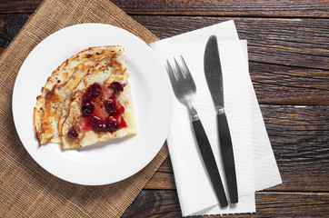 Pancake with jam and cutlery