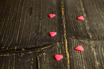 on the old dark table are small hearts