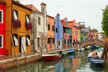 Fototapeta na wymiar Venice landmark, Burano island canal, colorful houses church and boats, Italy.