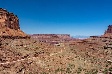 Fototapeta premium Gravel road leading to canyon, Canyonlands National Park Utah USA
