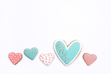Gingerbread cookies with frosting in the shape of a heart on white background. Valentines day concept. Flat lay, top view, copy space for text.