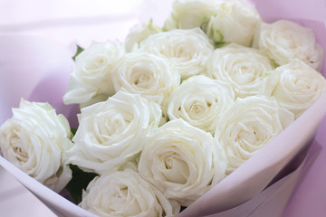 Beautiful tender bouquet of white roses. Background with light pastel colors