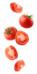 Fotobehang falling tomatoes isolated on a white background with a clipping path. © Elena