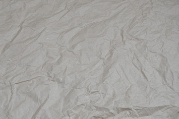 Top view beige crumpled wrapping paper. background