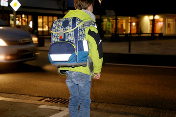 Schoolchild on the way to school after dark