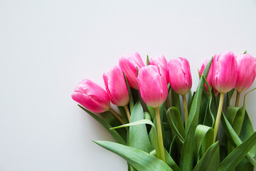 Fototapeta premium Bouquet of beautiful pink tulips on a white background, top view