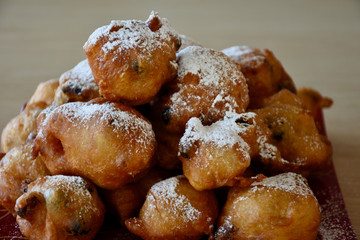  Pile of delicious 'oliebollen' : (deep-fried raisin bun) with powdered sugar: a Dutch delicacy