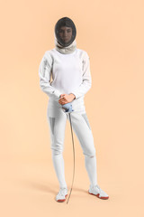 Fototapeta premium Young female fencer on color background