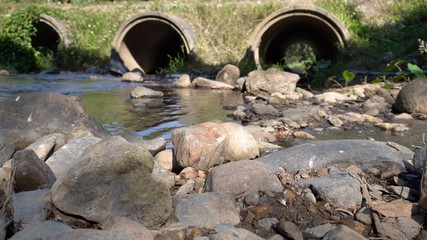 Reinforced concrete box culverts under the road with waterfall. Box culvert is a structure that...