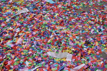 Fototapeta na wymiar Colorful Confetti Paper on the ground at Feast 