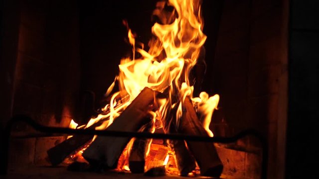 Fireplace buring in slow motion at night in the attic at home.Closeup Isolated