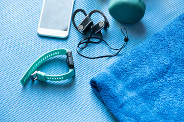 fitness equipment and electronics on a blue yoga mat