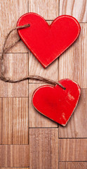 Vintage red hearts on wooden background