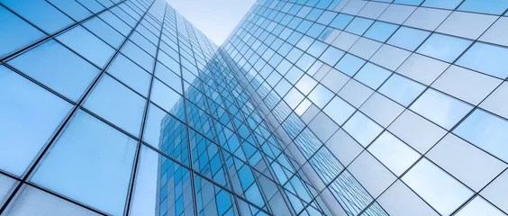 Foto op Aluminium glass facades of modern office buildings and reflection of blue sky © ahavelaar