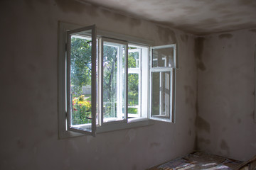 room repair with an open window, natural drying of the room after repair, puttying of walls in the...