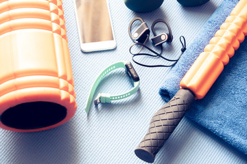 fitness and recovery equipment on a yoga mat