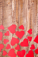 Composition of red hearts on a wooden background