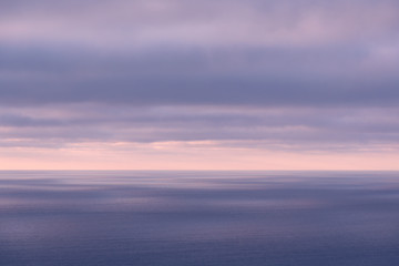 Long aerial view of evening clouds over Tasman sea coast