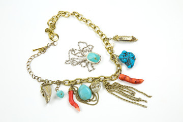 Necklace made of bright colored coral turquoise stones with metal chain Keychain with turquoise. Selective focus. Jewelry Fashion and beauty.